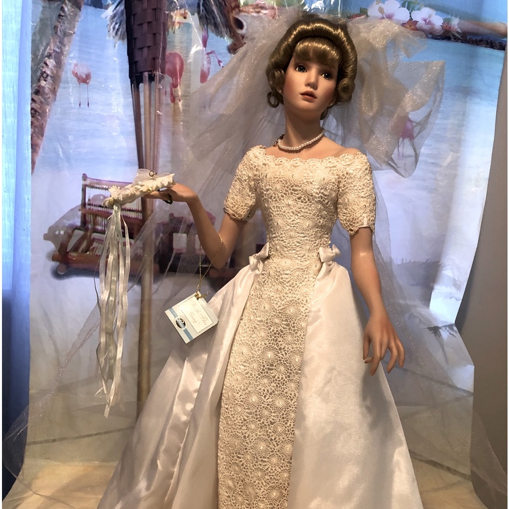 This beautiful porcelain bride doll is titled “With this ring”